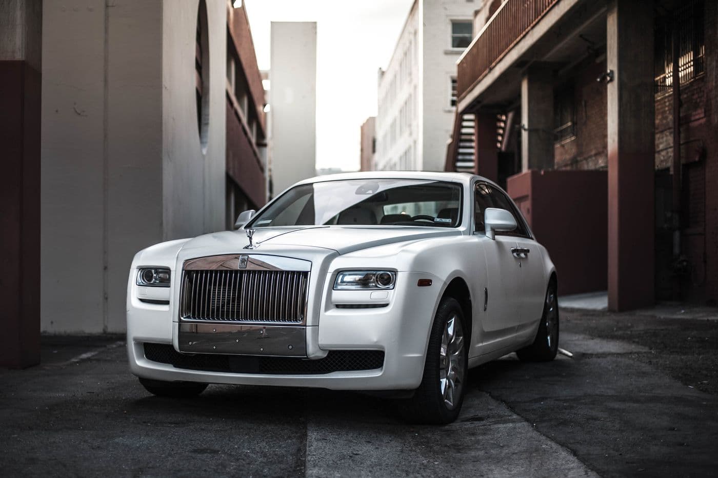 Pristine white Rolls-Royce sedan with a clean paint finish and chrome grille.